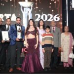 A group on stage with a trophy and certificate at the ARTA 2026 awards ceremony